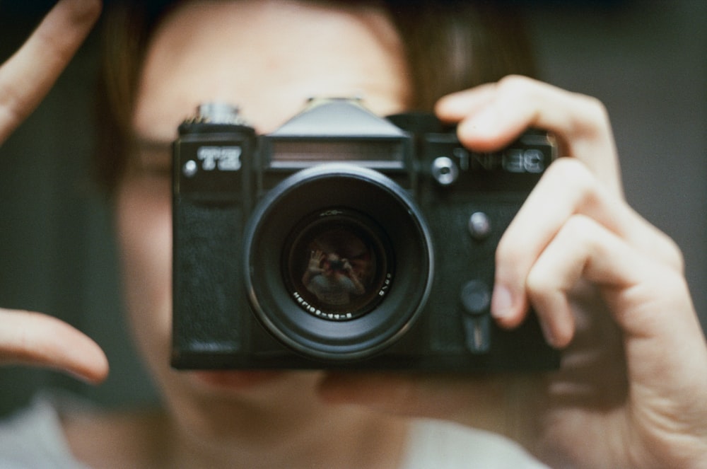 a person holding a camera up to their face