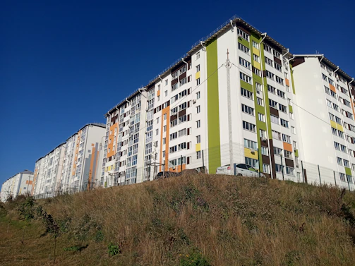 a very tall building sitting on top of a hill