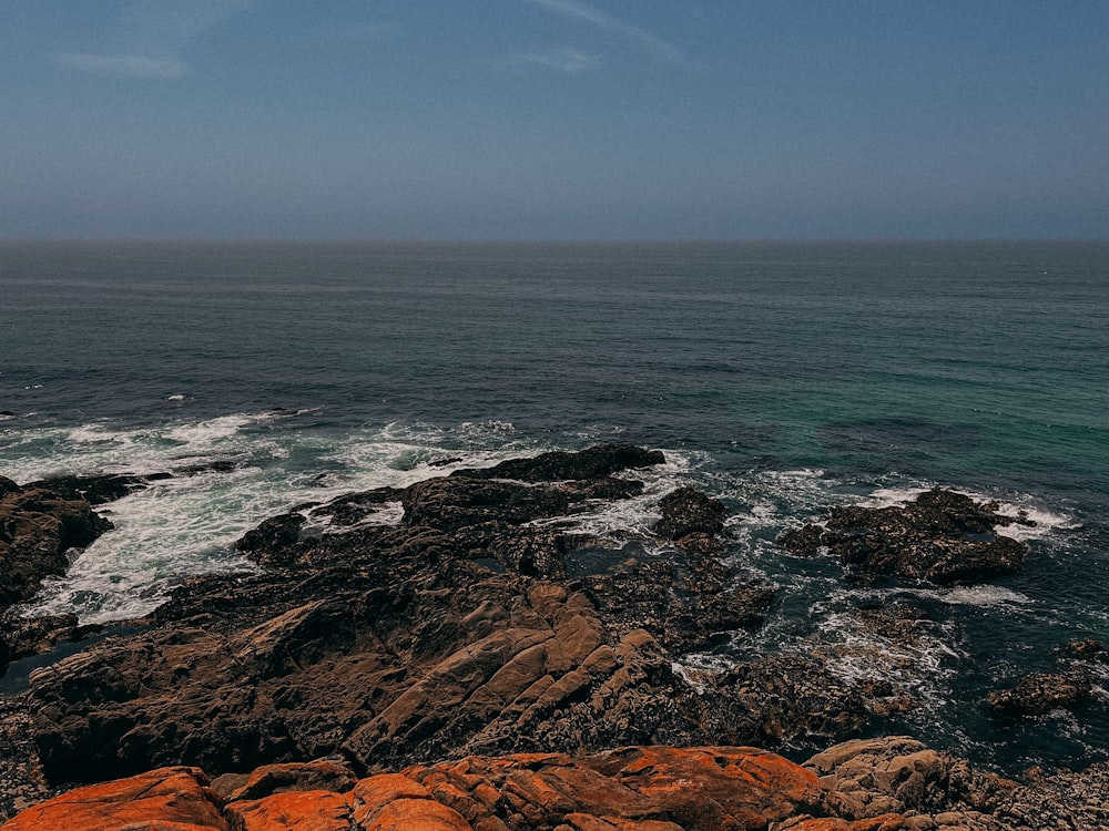 a view of the ocean from a rocky shore