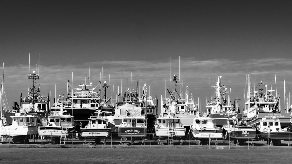 a black and white photo of many boats