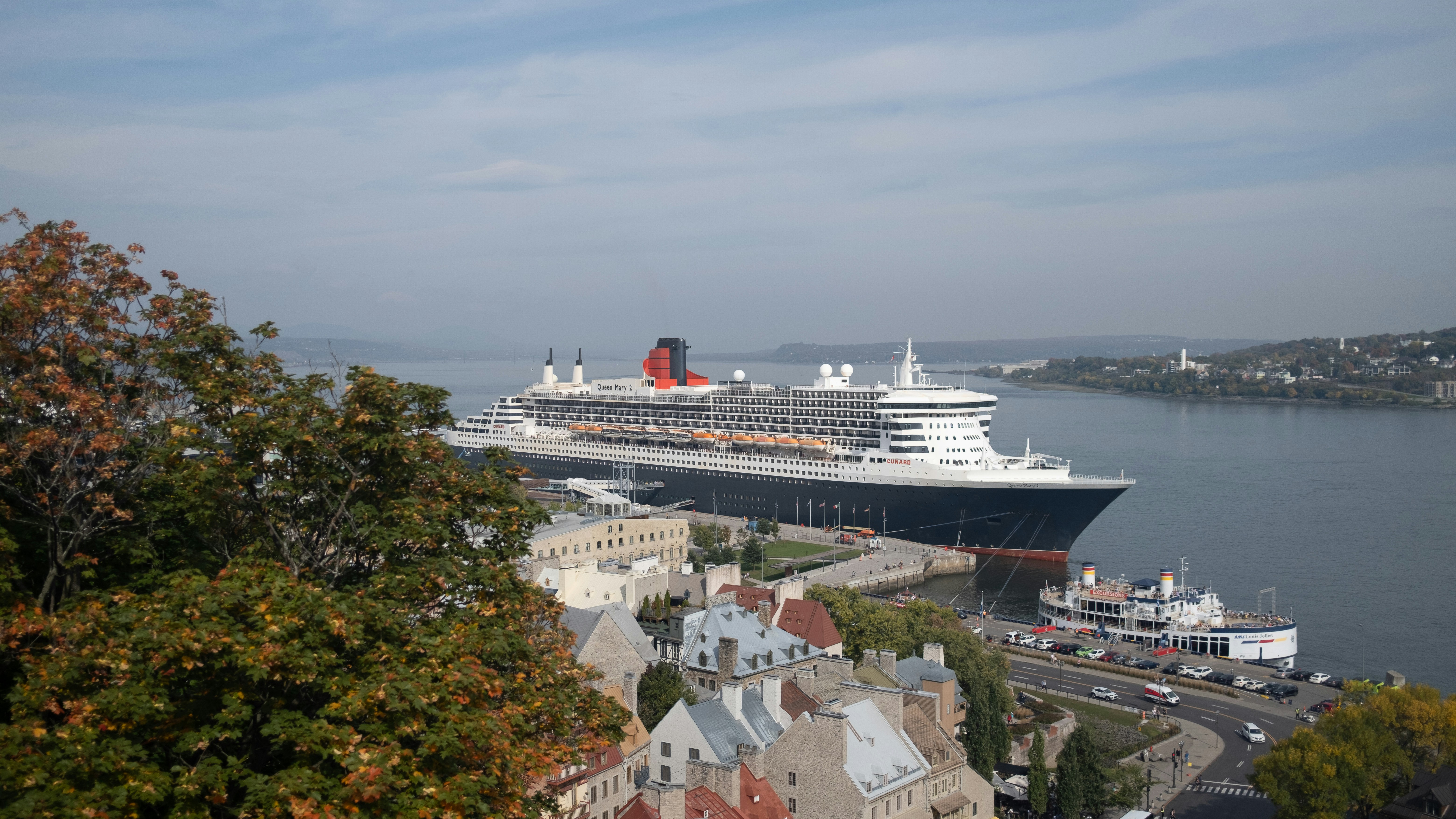 A Cunard ship alongside in port, seen from the quay