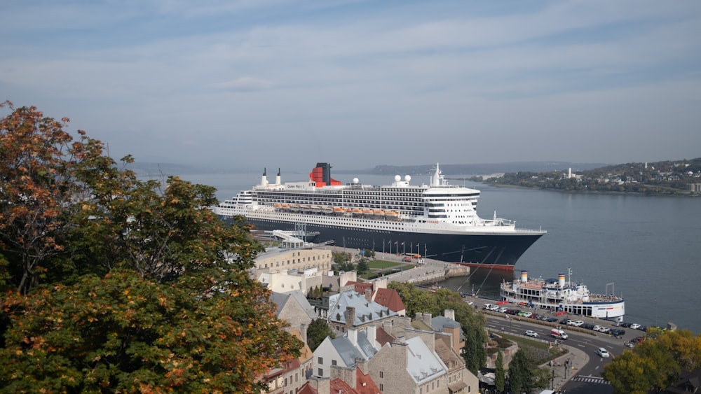 a cruise ship docked in a harbor next to a city