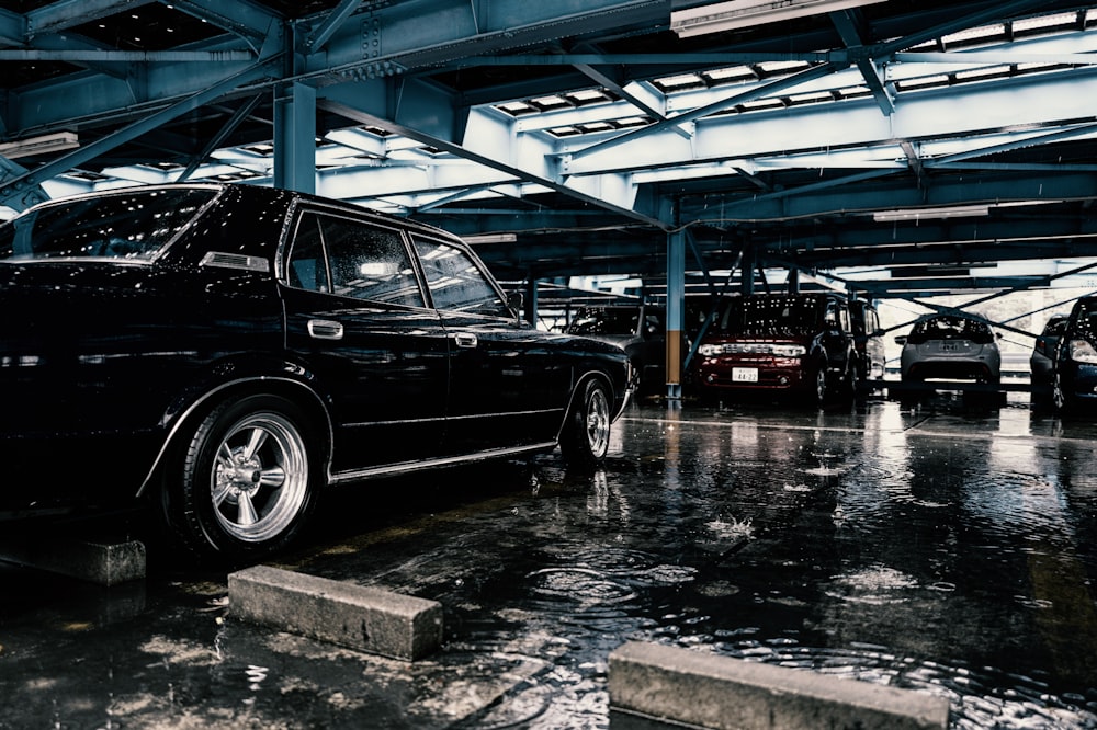 a black car parked in a parking garage