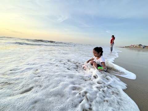 A joyful child playing with sea animal toys while a BCBA attentively guides the session.