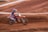 a person riding a dirt bike on a dirt track