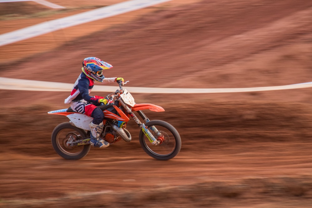 a person riding a dirt bike on a dirt track