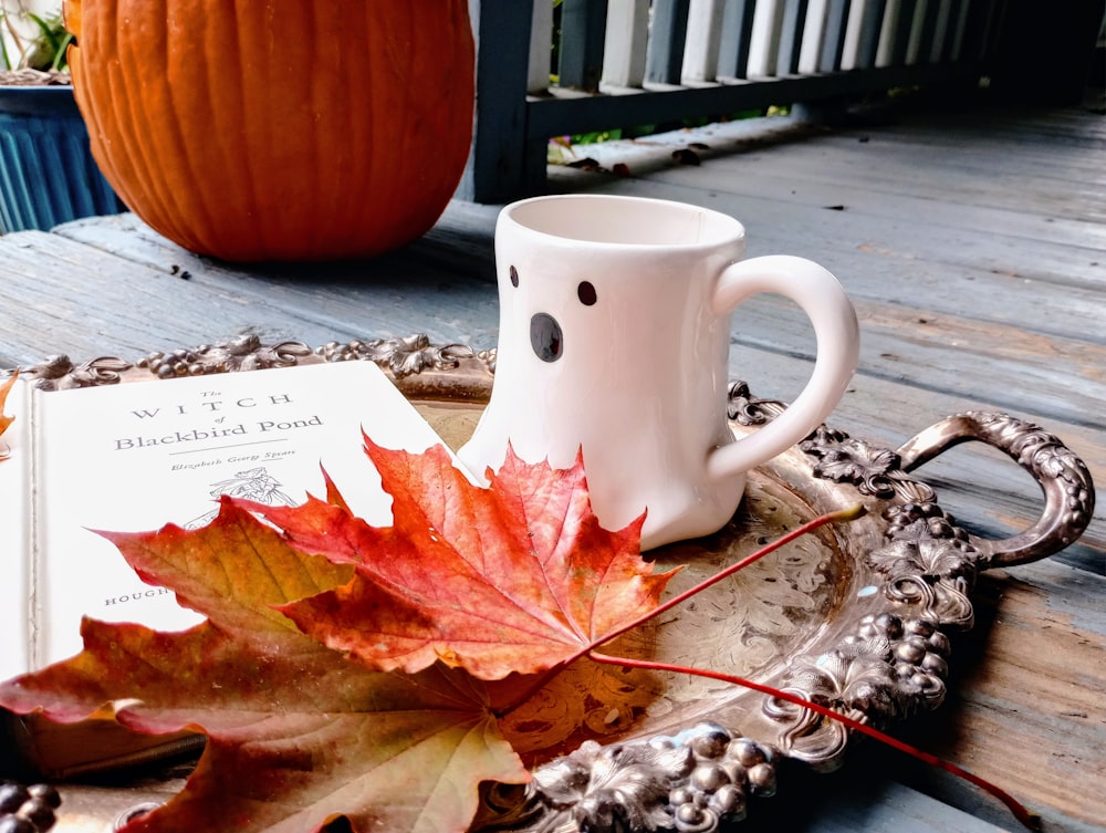 a cup of coffee and a book on a tray