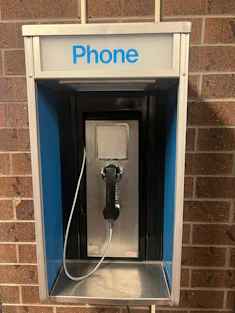 a phone booth with a phone hooked up to it