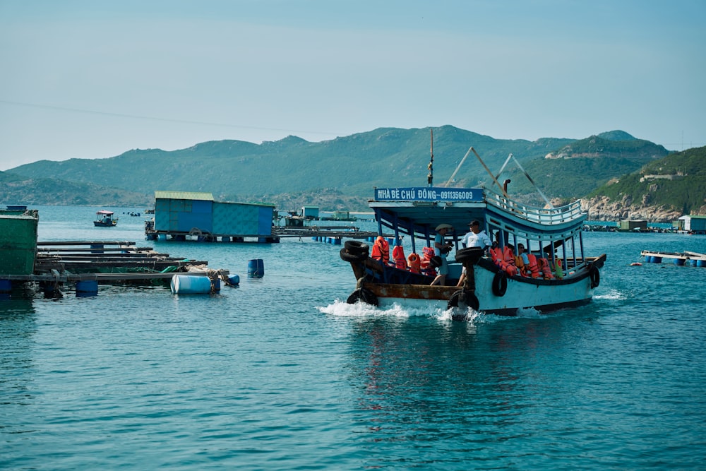 a boat with a bunch of people on it in the water