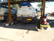 Close-up of a fuel tanker truck delivering certified urea at a mining site.