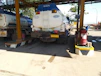 Close-up of a fuel tanker truck delivering certified urea at a mining site.