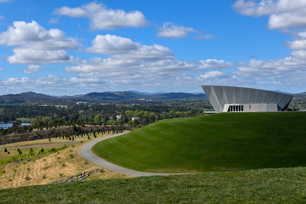 a large building on top of a lush green hillside