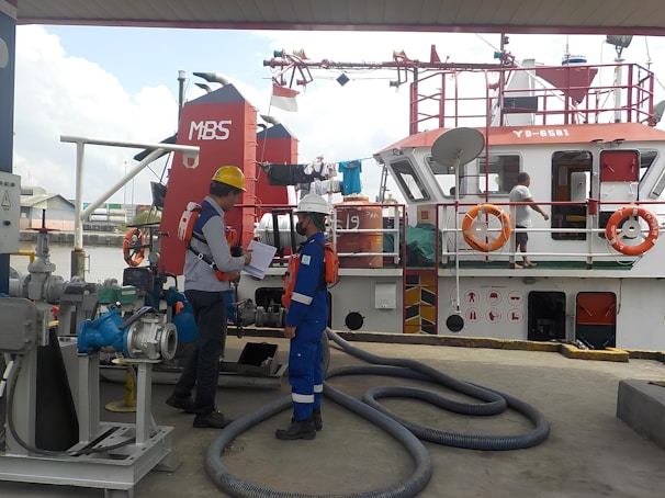 Professional marine surveyor discussing inspection results with a client on a dock.