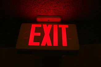 a red exit sign lit up in the dark