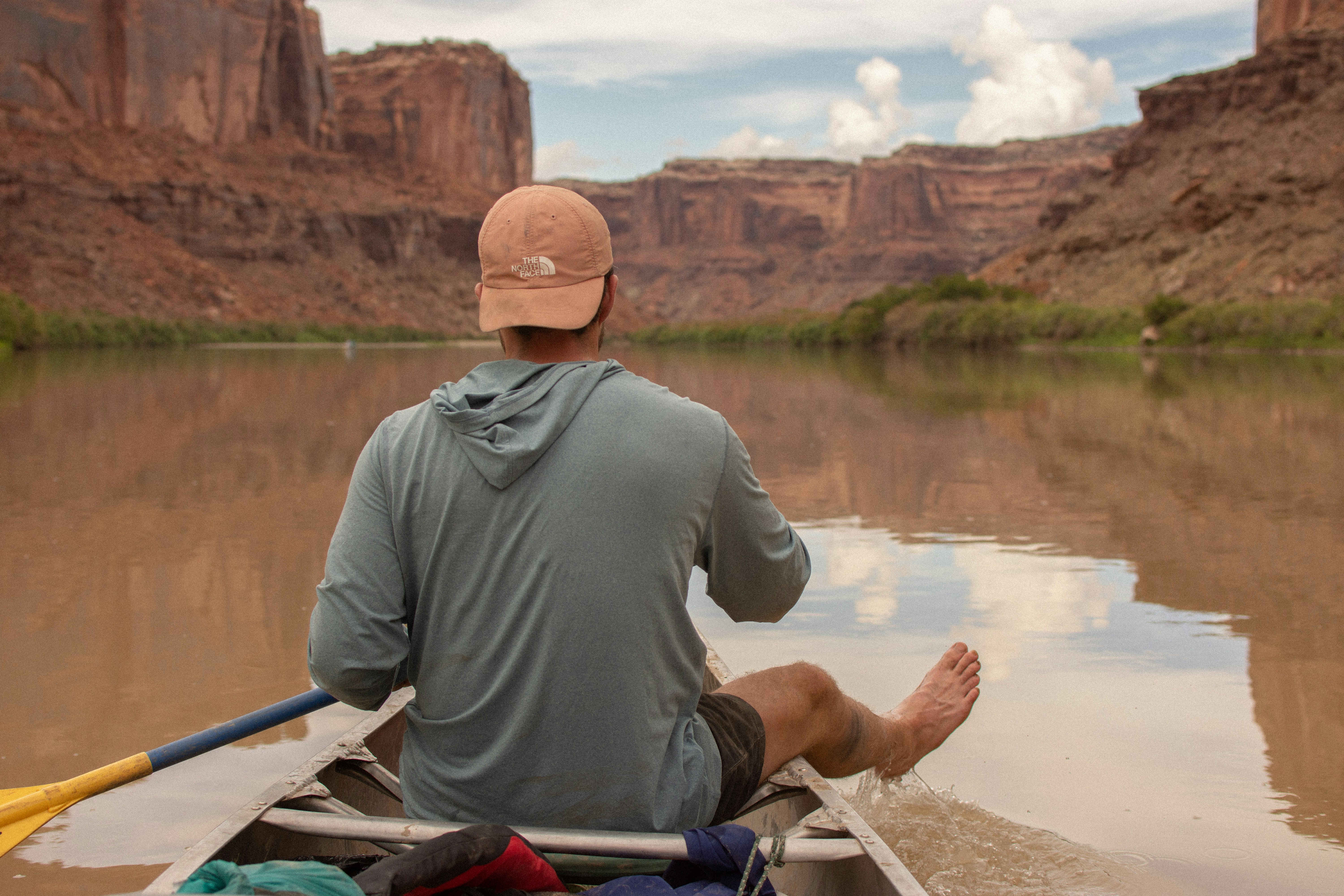 A man sitting in a canoe on a river