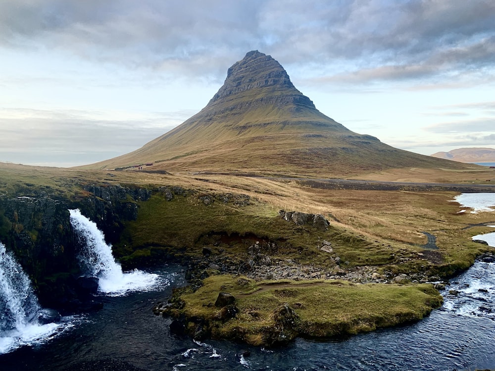 a mountain with a waterfall in the middle of it