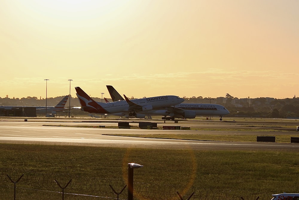 a couple of planes that are on a runway