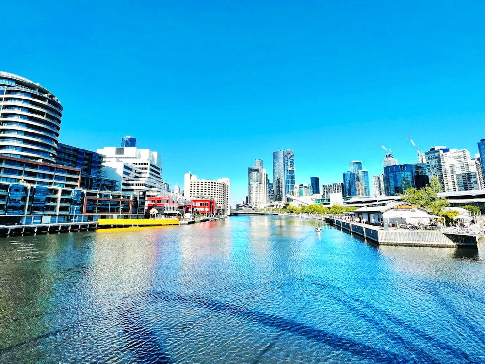 a river running through a city next to tall buildings