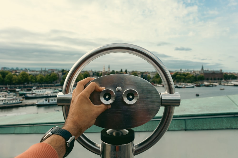 a person is looking through a telescope at a boat
