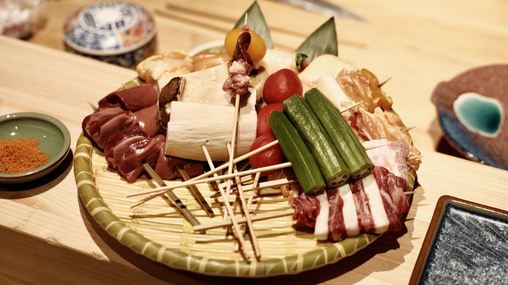 a platter of meats and cheeses on a wooden table