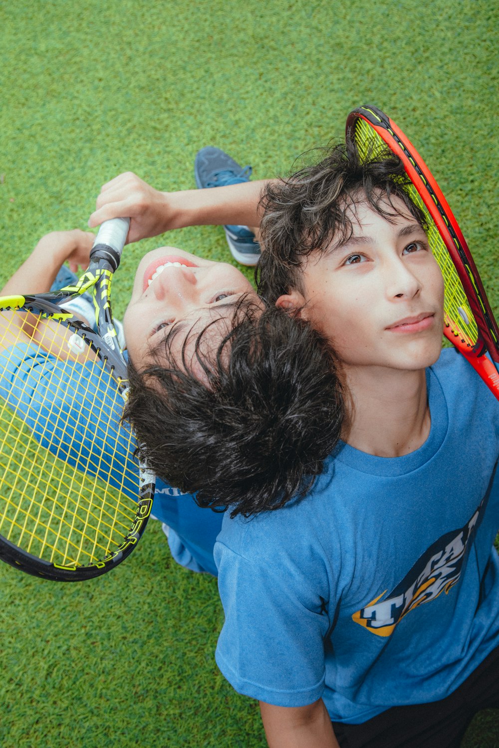 a couple of people that are holding tennis rackets