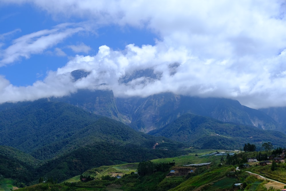 a scenic view of a mountain range with clouds in the sky