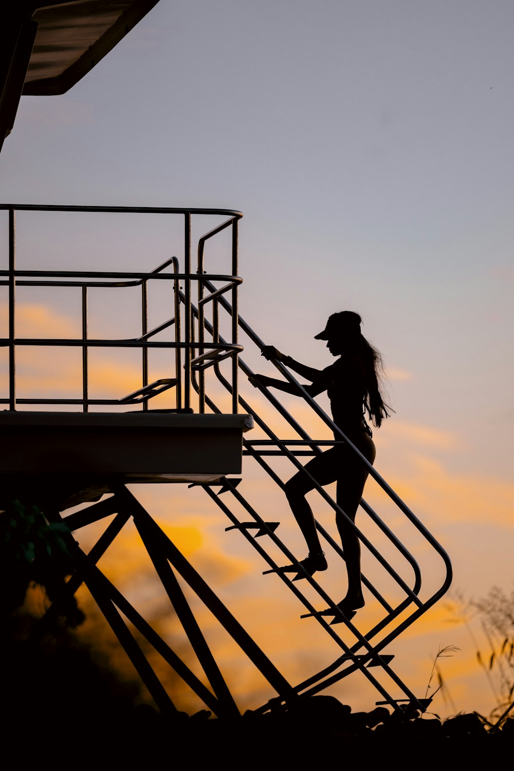 a woman climbing up a set of stairs