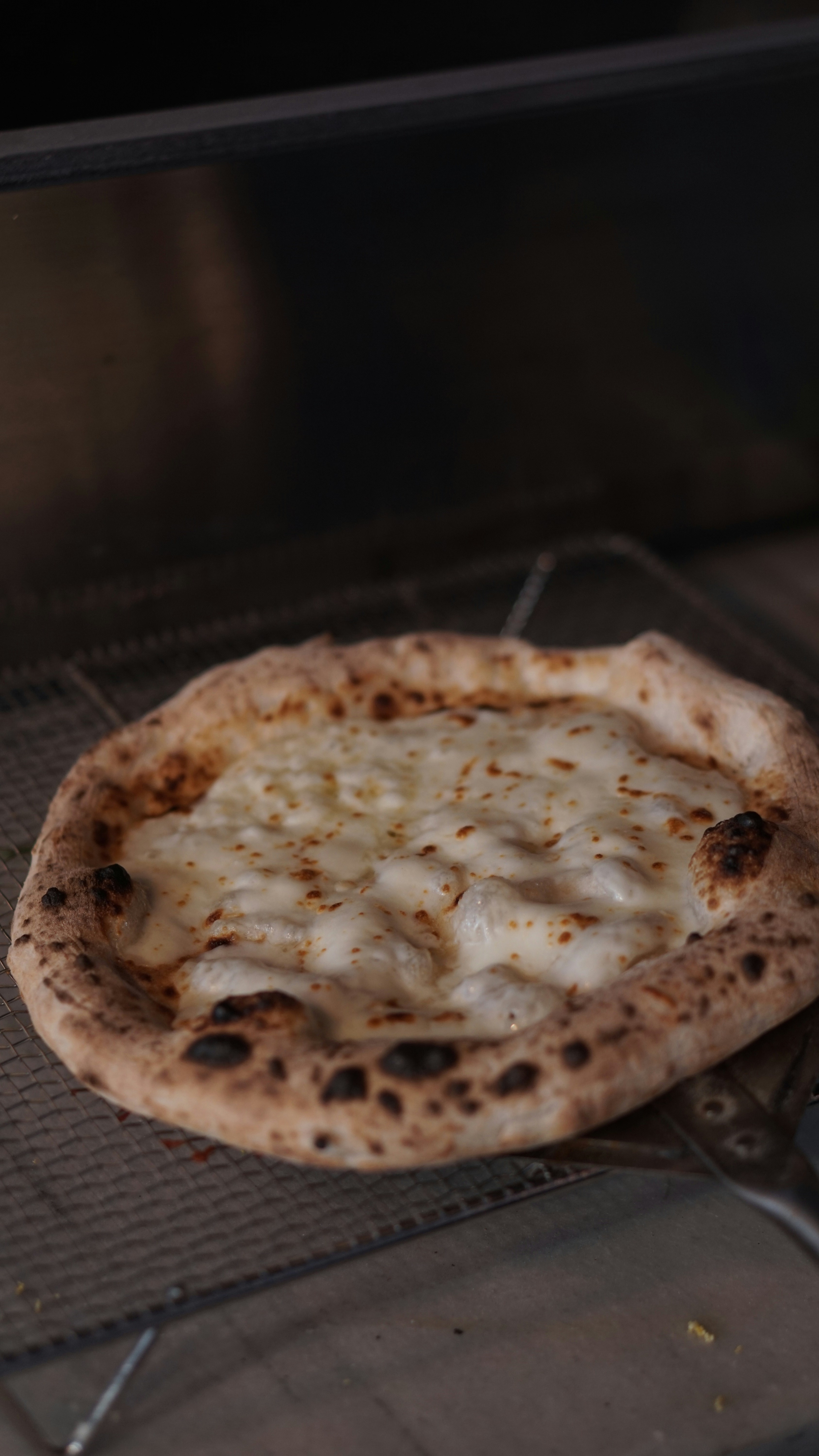 a pizza sitting on top of a metal rack