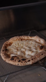 A hot, cheesy pizza fresh out of the oven with bubbling toppings.