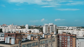 A vibrant cityscape with various residential buildings under a clear sky.
