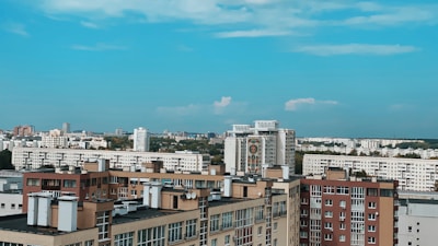 A vibrant cityscape with various residential buildings under a clear sky.