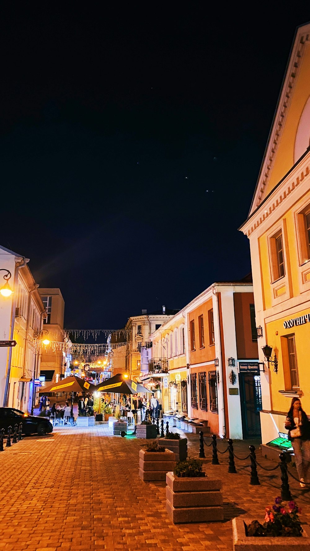 a cobblestone street at night in a european town