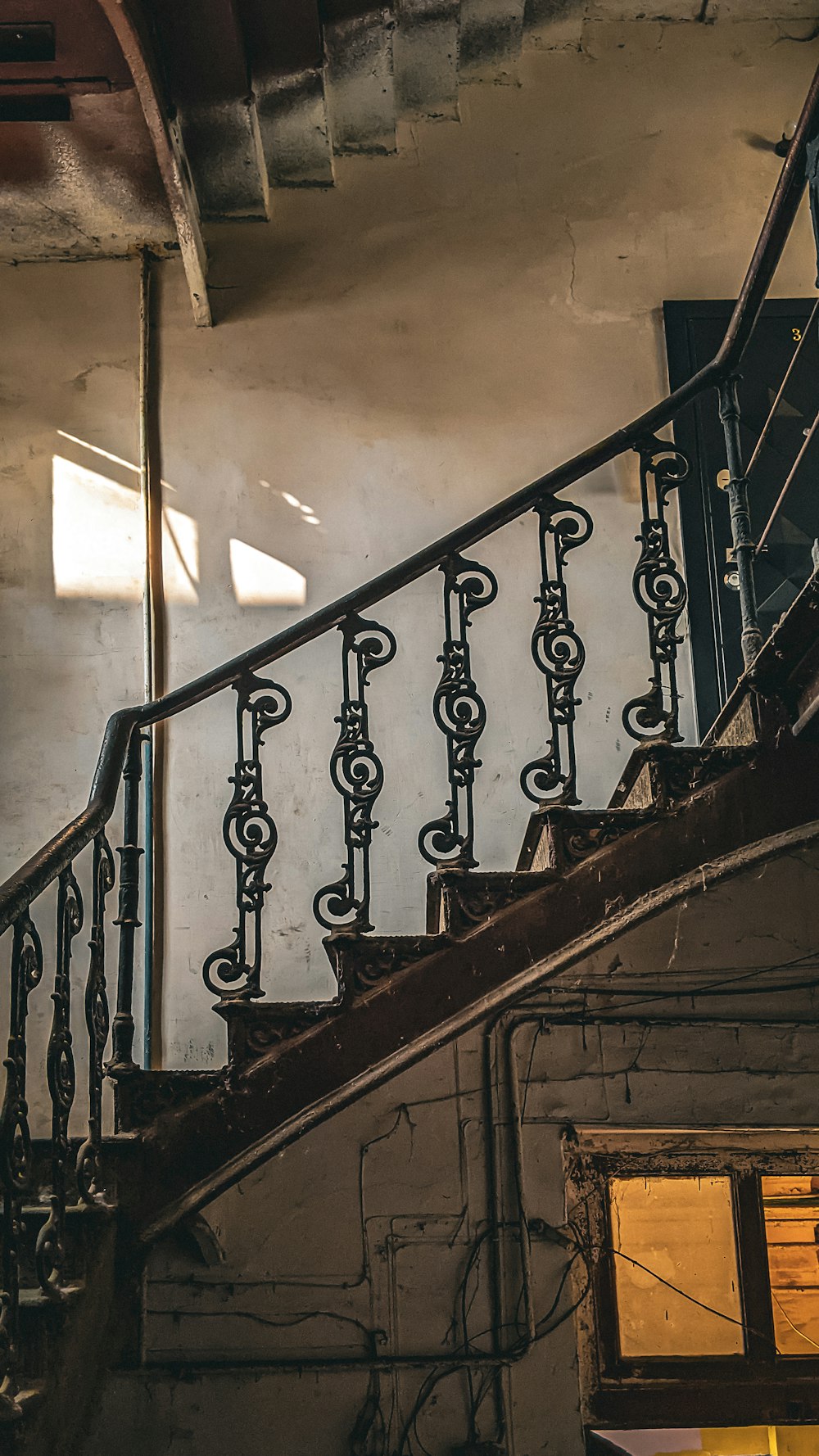 a stair case with a railing and a window