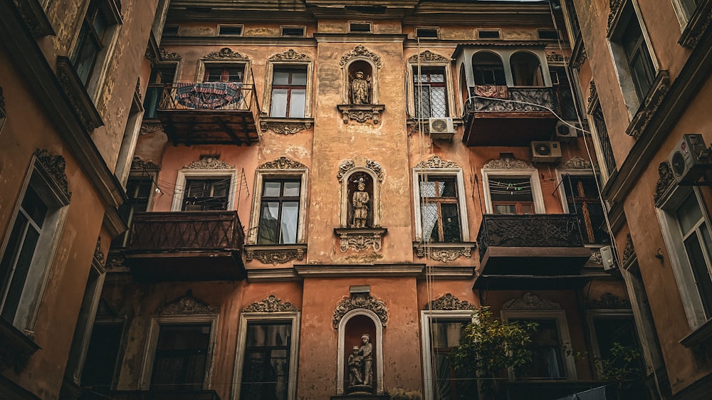 a tall building with lots of windows and balconies