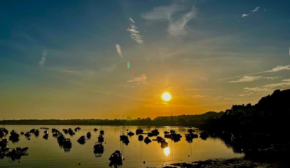 a group of boats floating on top of a lake