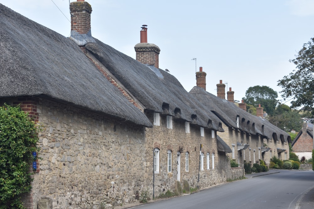 a row of stone houses with thatched roofs