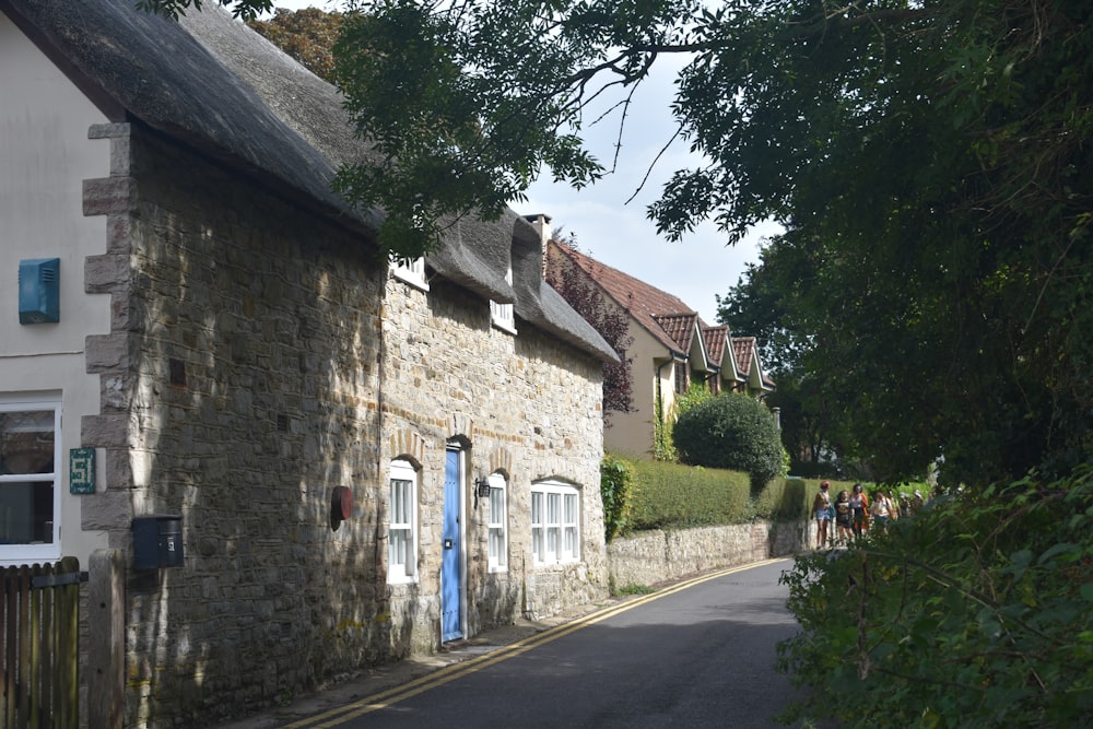 a narrow street lined with stone buildings and trees