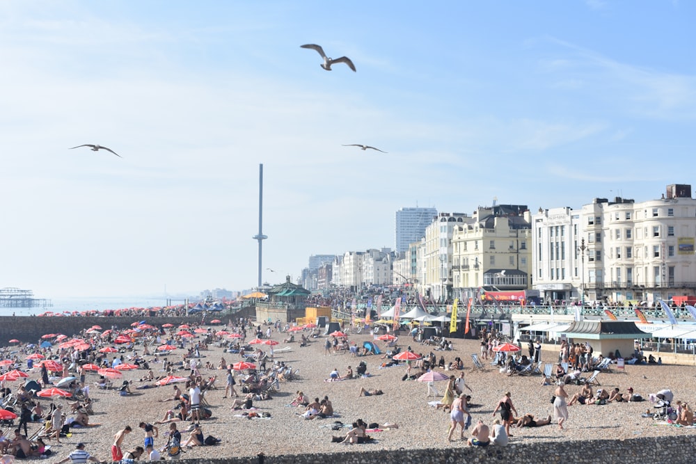 a crowded beach with lots of people on it