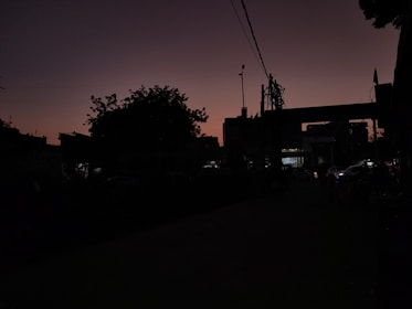 An urban landscape featuring contrasting shadows and architectural details at dusk.