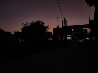 A minimalist black and white sketch of a city skyline at dusk.