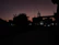 A softly lit silhouette of a city skyline at dusk, evoking a sense of discreet urban encounters.