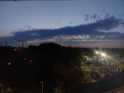 An aerial view of a sprawling energy project site under construction at dusk.