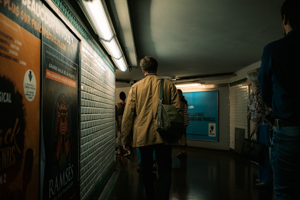 a group of people walking down a hallway