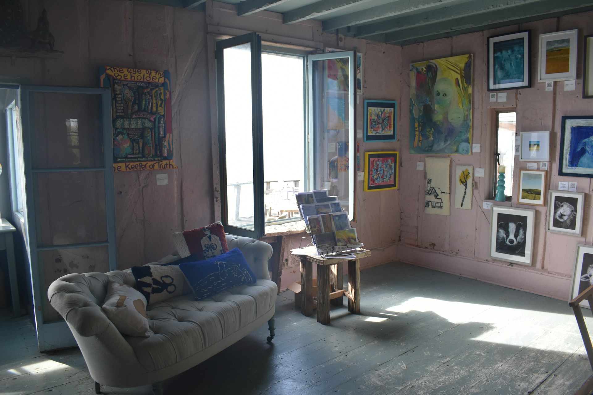 a living room filled with furniture and pictures on the wall