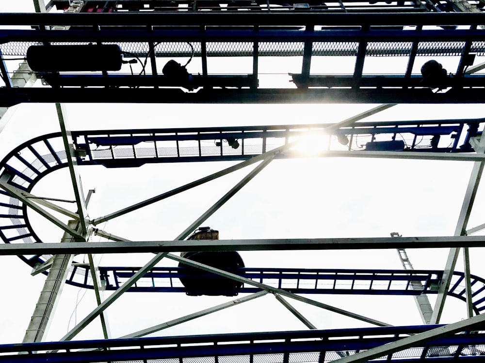 a ferris wheel with the sun shining through it