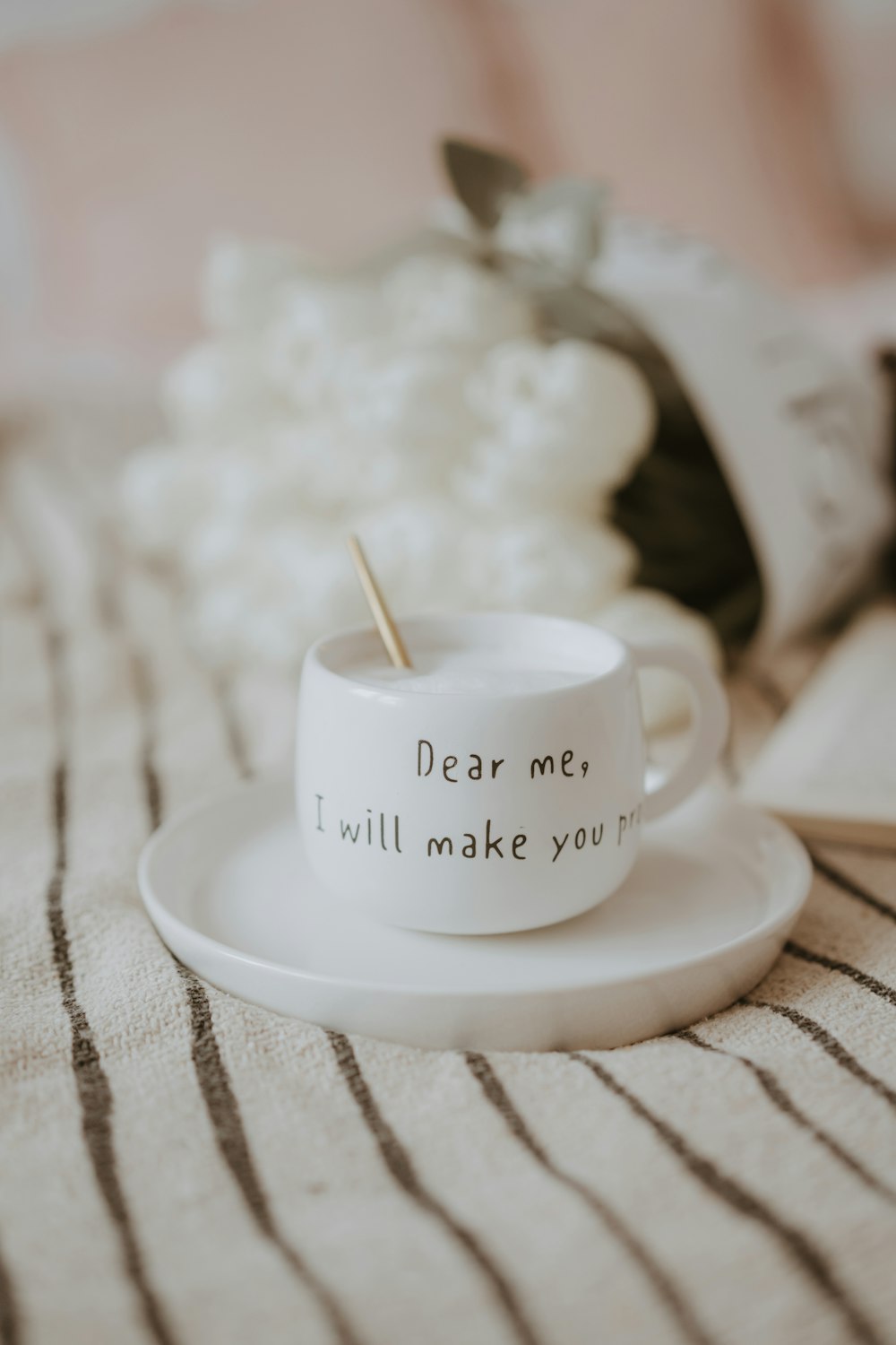 a cup with a spoon in it sitting on a saucer