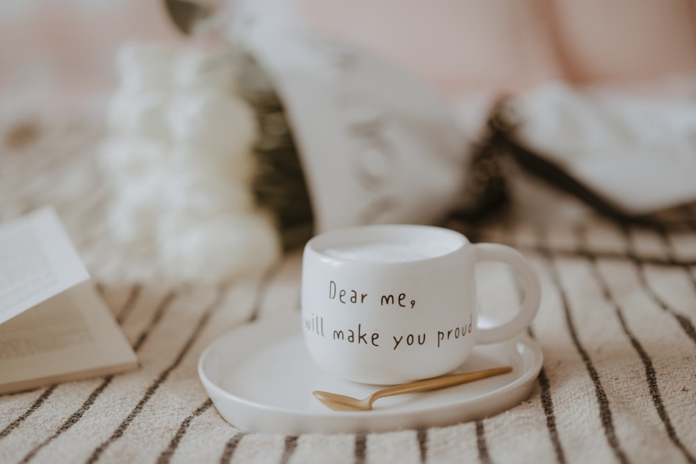 a coffee cup sitting on top of a white plate