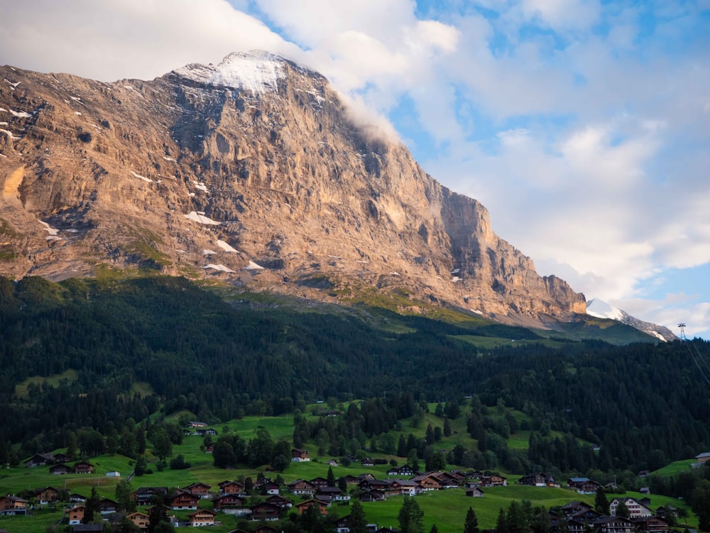 a view of a mountain with a village in the foreground