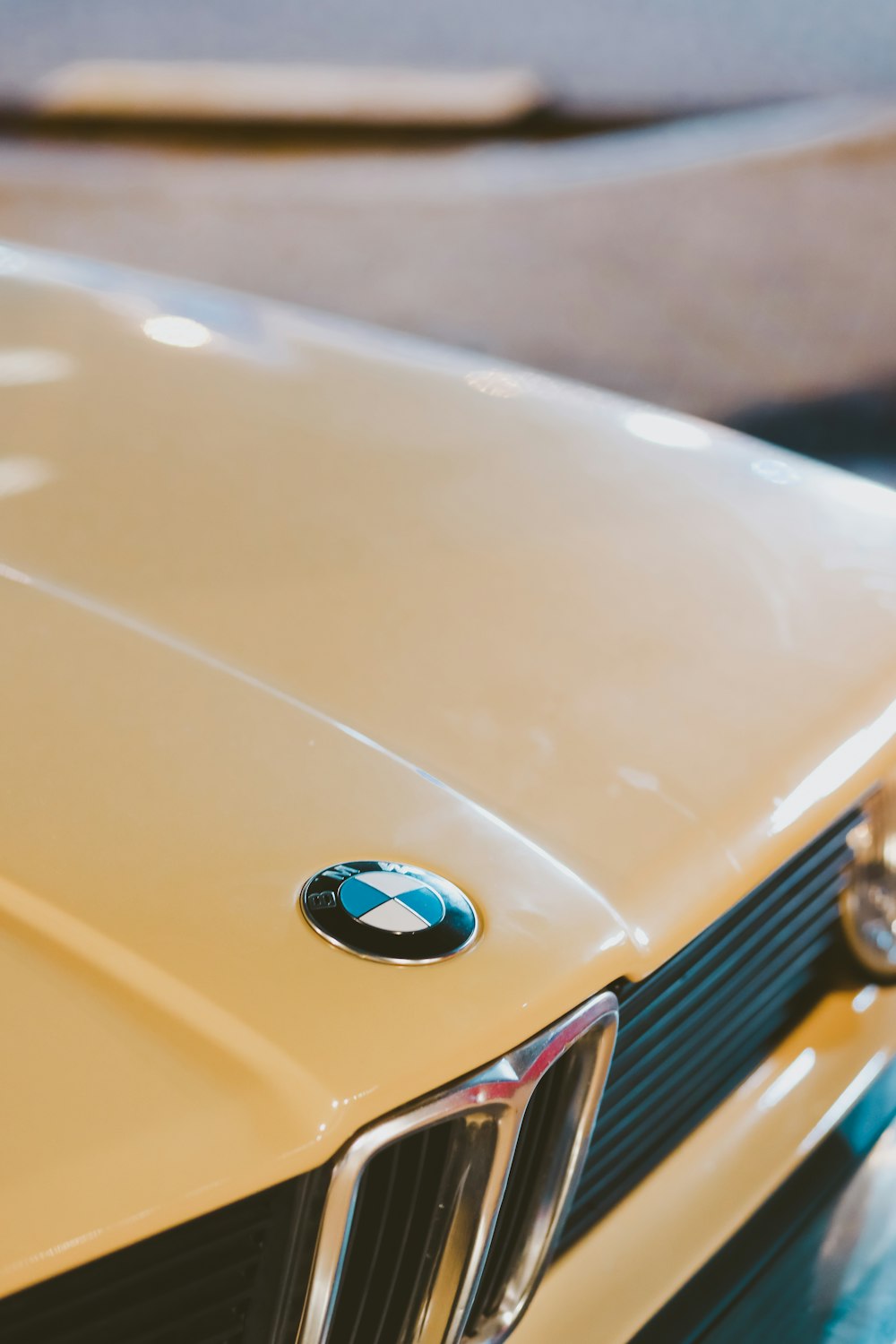 a close up of the front of a yellow car