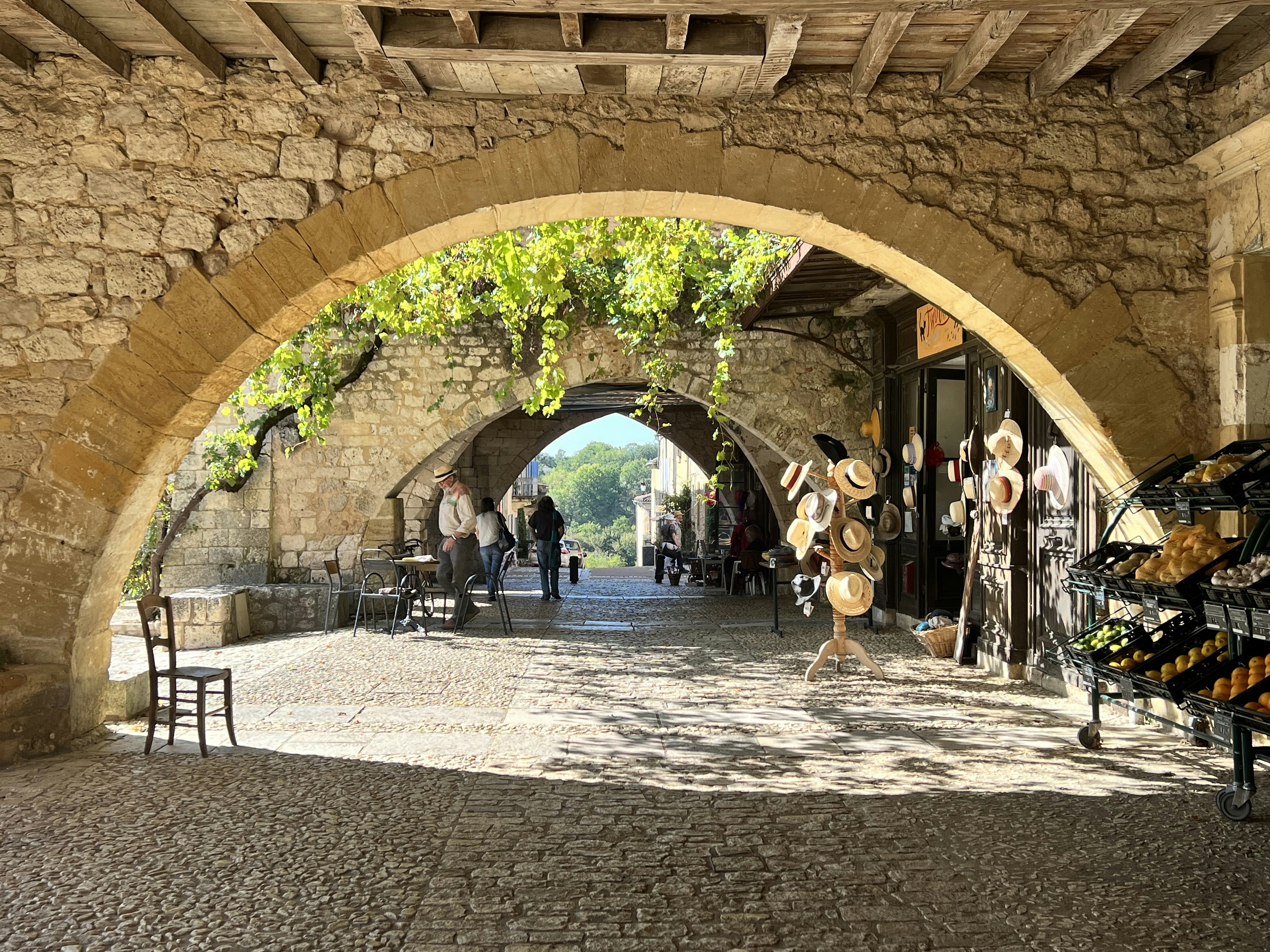 a cobblestone street with a stone archway